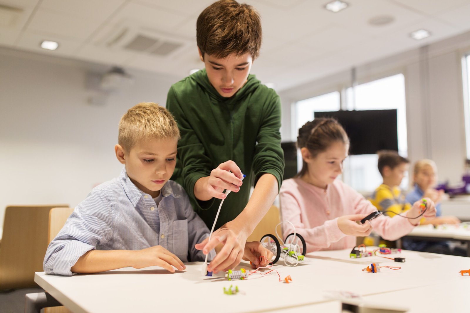 Students in a group therapy session at our Bahrain center work together to build robots, developing fine motor and problem-solving skills.