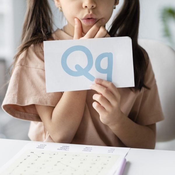 little-girl-holding-paper-with-letter-it-speech-therapy little-girl-holding-paper-with-letter-it-speech-therapy