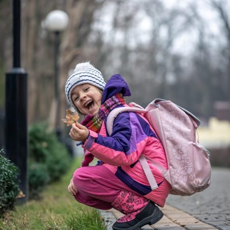 little-girl-looks-leaves-outside-cold-season-min little-girl-looks-leaves-outside-cold-season-min
