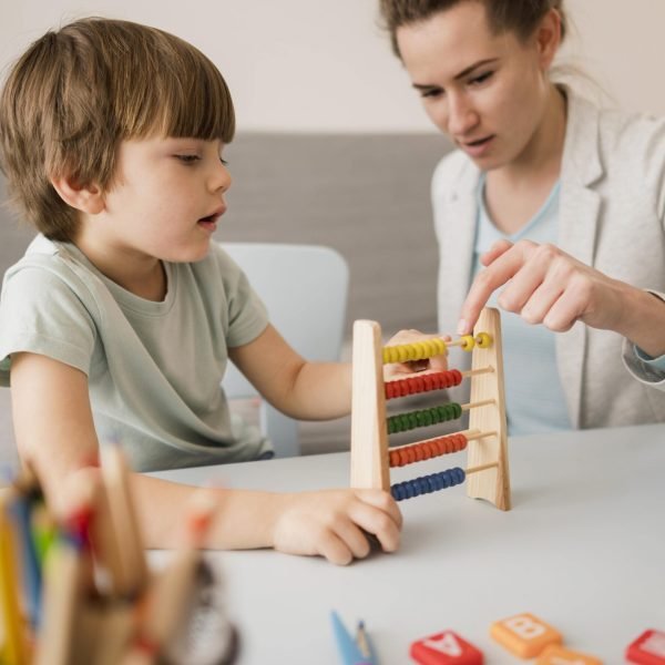 side-view-tutor-teaching-child-how-use-abacus (1)-min side-view-tutor-teaching-child-how-use-abacus (1)-min